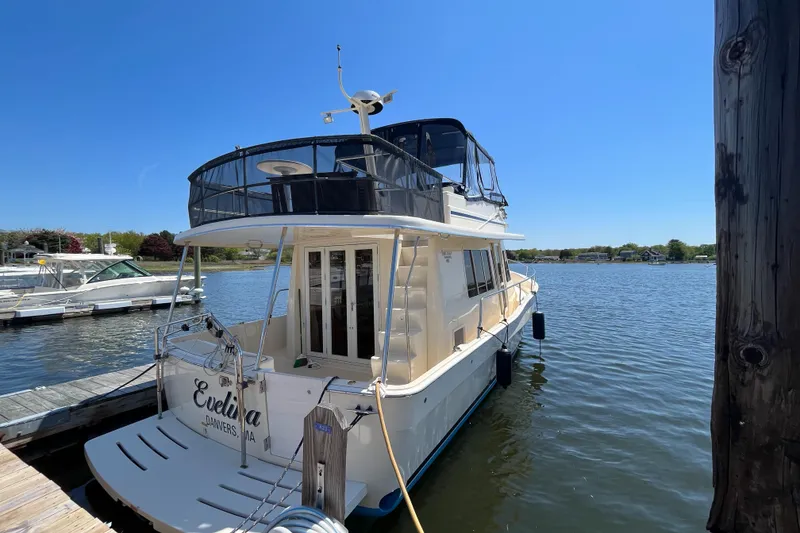 Slide: The Image of 2005 Mainship 400 Trawler docked on a sunny day, rear view. - 5