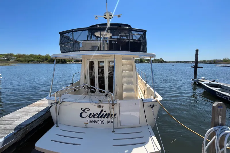 Slide: The Image of 2005 Mainship 400 Trawler docked on a sunny day, rear view. - 6