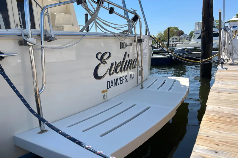 Slide: The Image of 2005 Mainship 400 Trawler docked, featuring "Evelina" name and Danvers, MA location. - 9