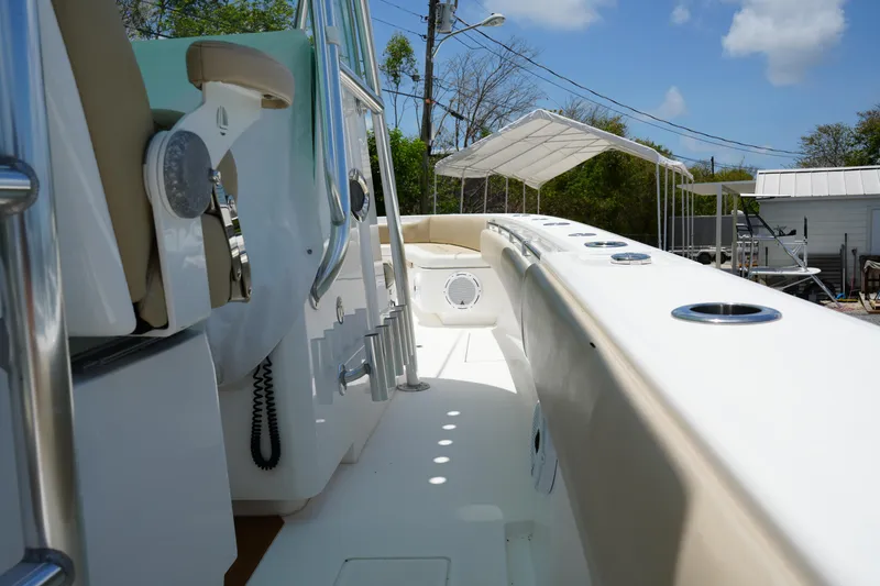Slide: The Image of 2015 Contender 39ST boat deck with seating and rod holders under a sunny sky. - 10