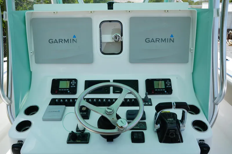 Slide: The Image of 2015 Contender 39ST boat dashboard with Garmin navigation displays and steering wheel. - 11