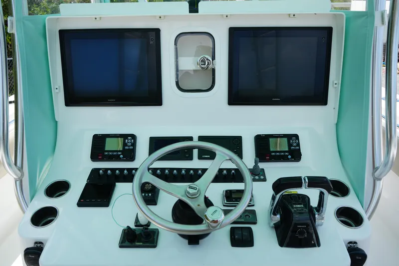 Slide: The Image of 2015 Contender 39ST boat dashboard with dual screens and steering wheel. - 12