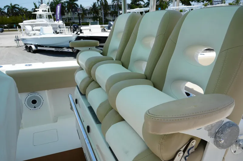 Slide: The Image of 2015 Contender 39ST boat seating with beige and white cushioned seats. - 14