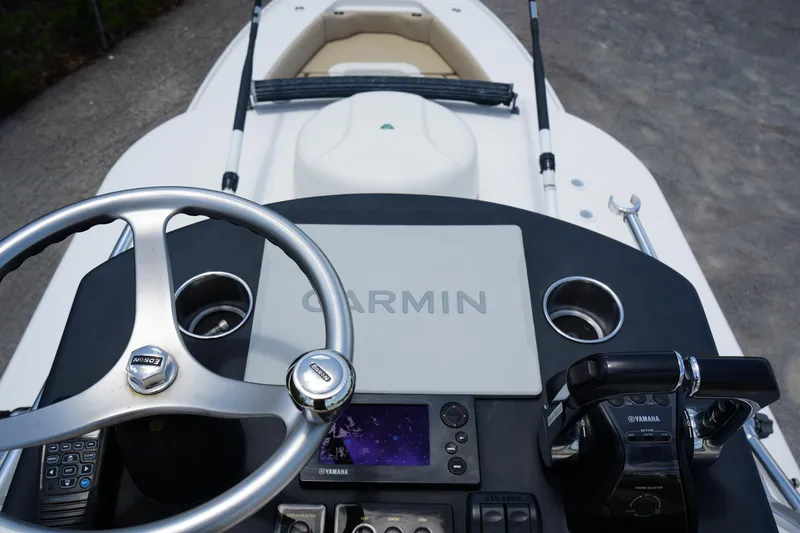 Slide: The Image of 2015 Contender 39ST boat dashboard with Garmin navigation system and steering wheel. - 18