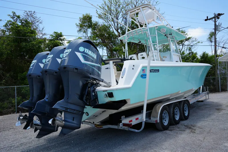 Slide: The Image of 2015 Contender 39ST boat with triple Yamaha engines on a trailer. - 3