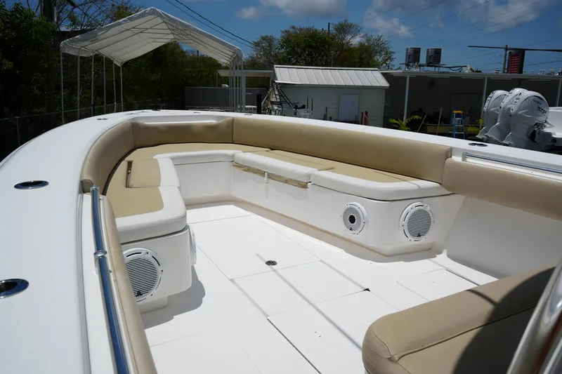 Slide: The Image of 2015 Contender 39ST boat interior with beige seating and built-in speakers. - 5