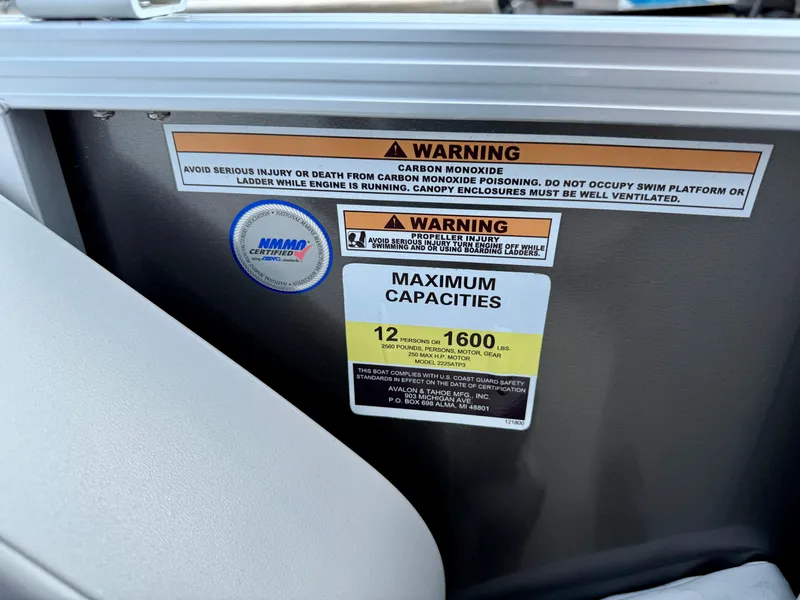 Slide: The Image of Warning labels and capacity limits on 2025 Avalon LSZ Cruise Rear Bench boat. - 13