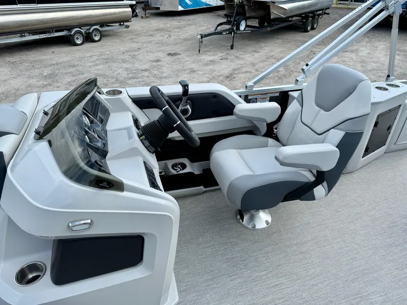 Slide: The Image of 2025 Avalon LSZ Cruise Rear Bench boat interior with modern helm and comfortable captain's chair. - 14