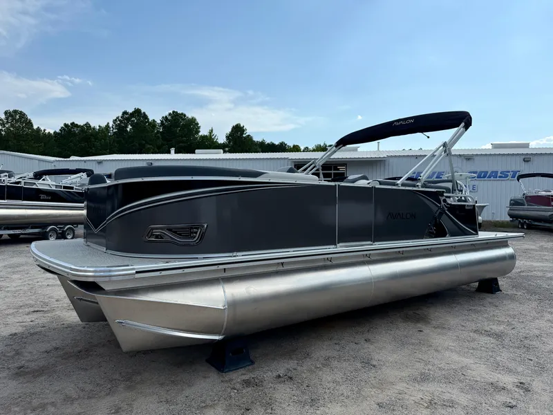 Slide: The Image of 2025 Avalon LSZ Cruise Rear Bench pontoon boat in a dealership lot. - 18