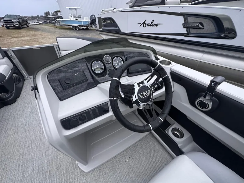 Slide: The Image of 2025 Avalon LSZ Cruise Rear Bench boat interior with modern dashboard and steering wheel. - 7