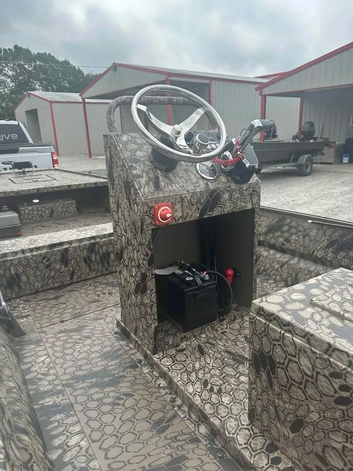 Slide: The Image of 2025 Pro-Drive 2054 X Series TD boat with camouflage design and steering console. - 2