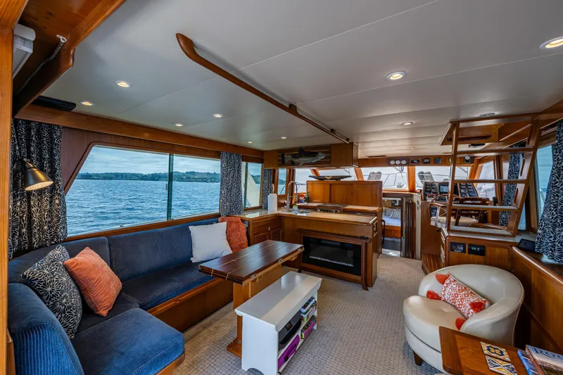 Slide: The Image of Interior of 1997 Offshore Yachts 52 Sedan with cozy seating and panoramic windows. - 13