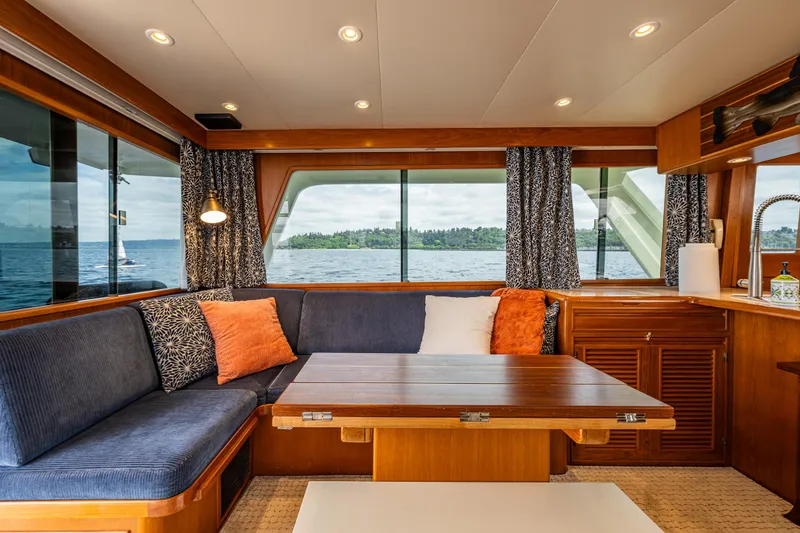 Slide: The Image of Interior of 1997 Offshore Yachts 52 Sedan with cozy seating and ocean view. - 19