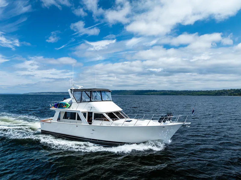 Slide: The Image of Offshore Yachts 52 Sedan, 1997 model, cruising on open water under a blue sky. - 2