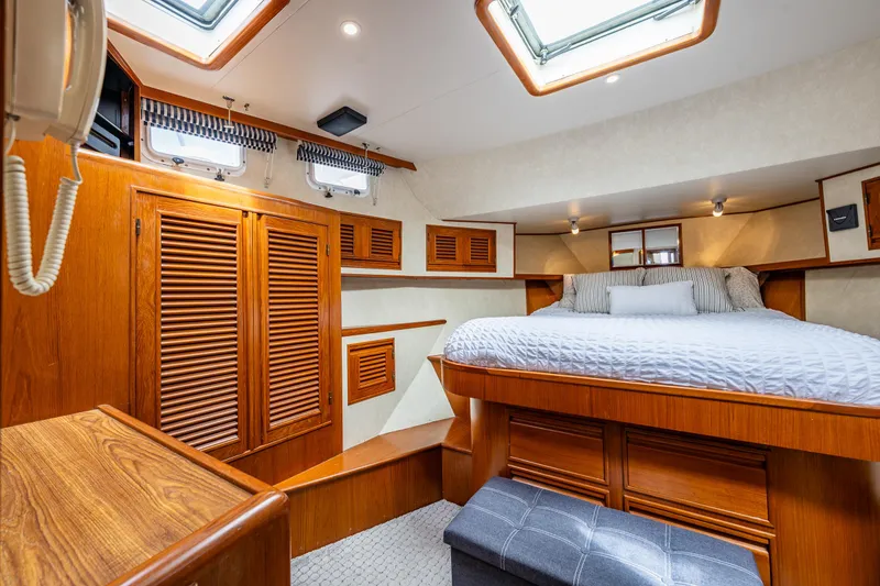Slide: The Image of Luxurious cabin interior of 1997 Offshore Yachts 52 Sedan with wood finishes and skylights. - 26