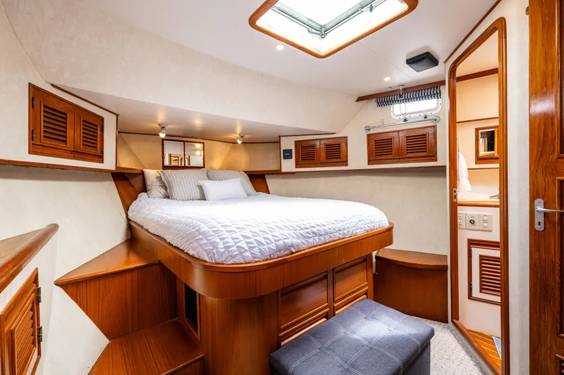 Slide: The Image of Luxurious cabin interior of 1997 Offshore Yachts 52 Sedan with cozy bed and wooden accents. - 29