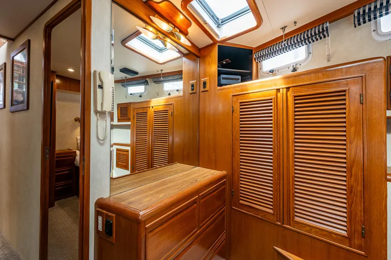 Slide: The Image of Interior of 1997 Offshore Yachts 52 Sedan with wooden cabinetry and skylights. - 30