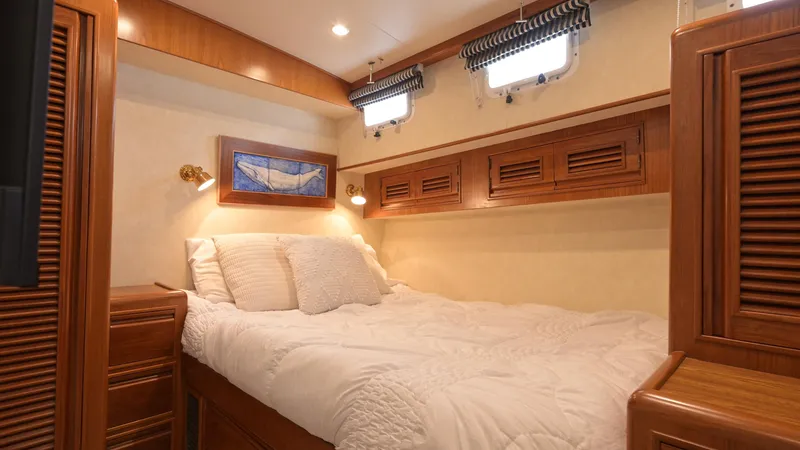 Slide: The Image of Luxurious cabin interior of 1997 Offshore Yachts 52 Sedan with cozy bed and wooden accents. - 31