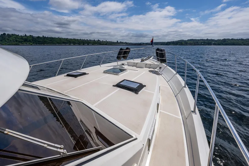 Slide: The Image of 1997 Offshore Yachts 52 Sedan cruising on a serene lake under a partly cloudy sky. - 39