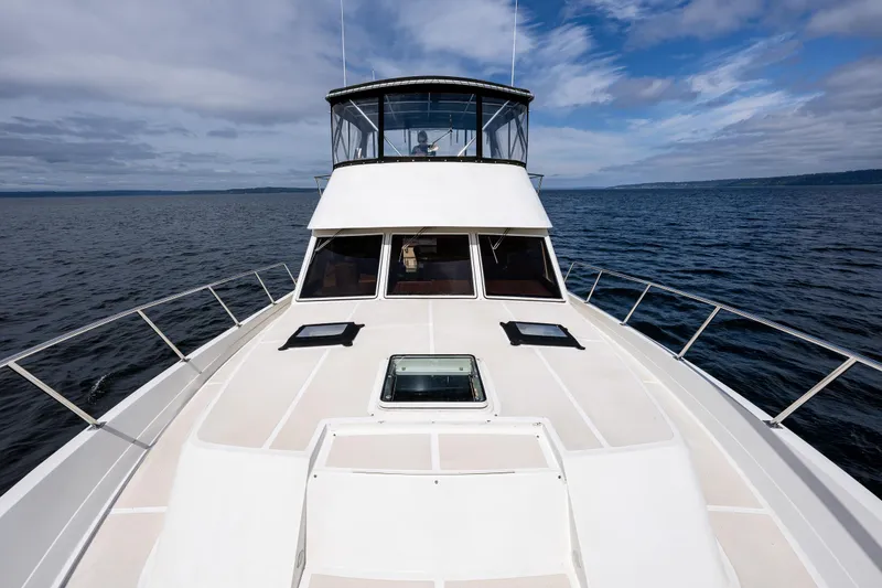Slide: The Image of Offshore Yachts 1997 52 Sedan cruising on open water under a cloudy sky. - 41