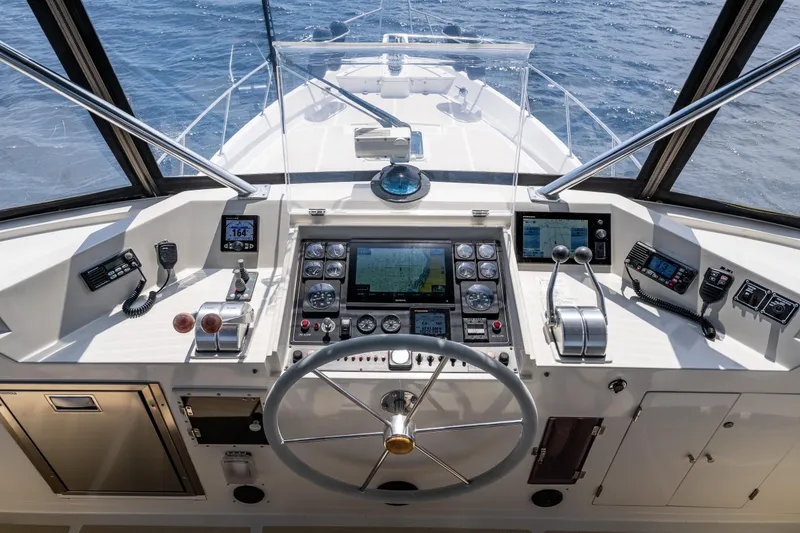 Slide: The Image of Cockpit of 1997 Offshore Yachts 52 Sedan with navigation instruments and steering wheel. - 44