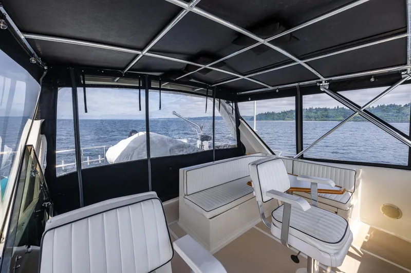 Slide: The Image of Interior view of 1997 Offshore Yachts 52 Sedan with seating and ocean backdrop. - 45