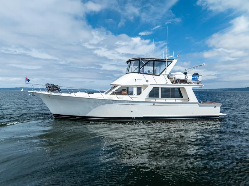 Slide: The Image of Offshore Yachts 52 Sedan 1997 cruising on open water under a partly cloudy sky. - 5