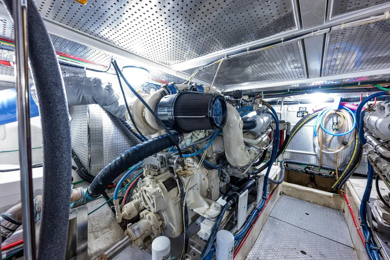 Slide: The Image of Engine room of 1997 Offshore Yachts 52 Sedan, showcasing complex machinery and wiring. - 50