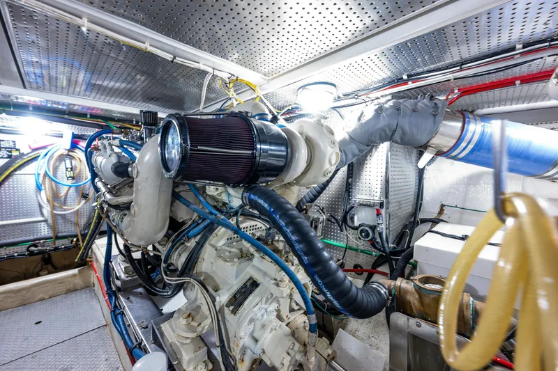 Slide: The Image of Engine room of a 1997 Offshore Yachts 52 Sedan, showcasing complex machinery and wiring. - 51