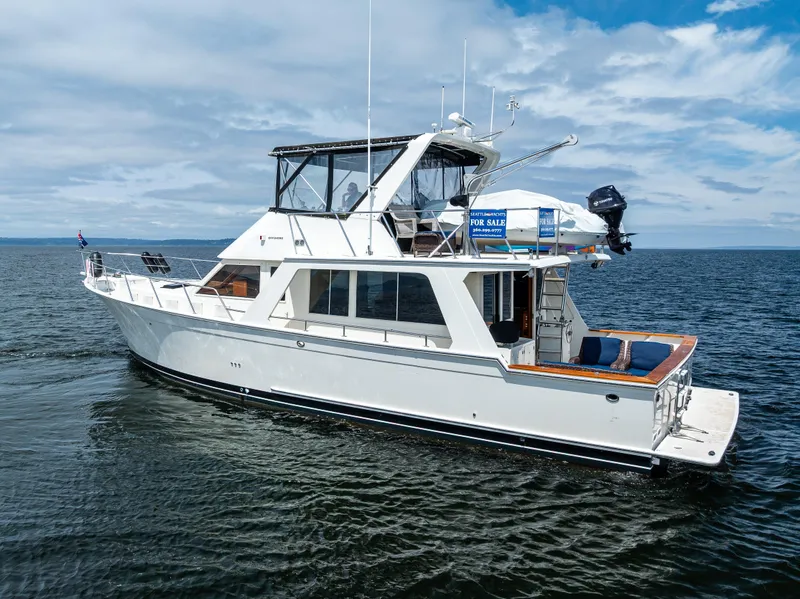 Slide: The Image of Offshore Yachts 52 Sedan 1997 cruising on open water under a partly cloudy sky. - 6