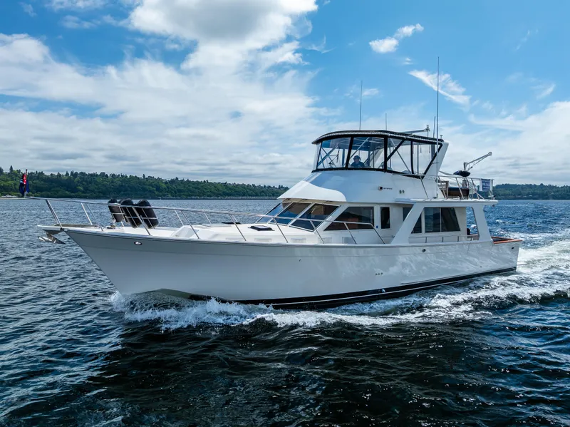 Slide: The Image of Offshore Yachts 1997 52 Sedan cruising on open water under a partly cloudy sky. - 7