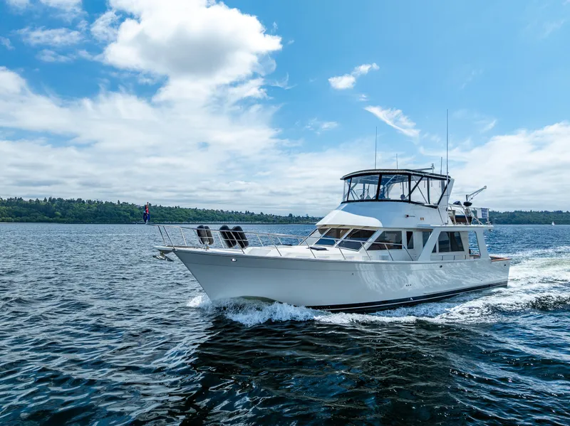 Slide: The Image of Offshore Yachts 52 Sedan, 1997 model, cruising on open water under a clear sky. - 8