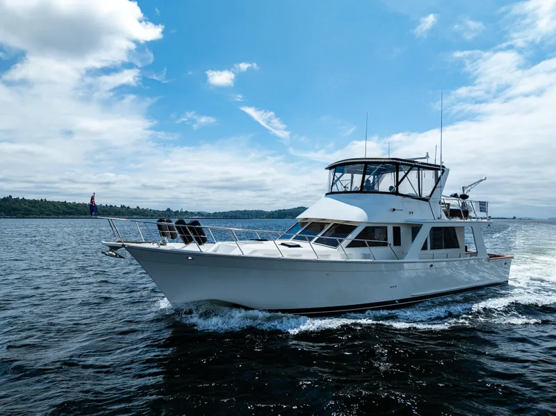 Slide: The Image of Offshore Yachts 52 Sedan 1997 cruising on open water under a clear blue sky. - 9
