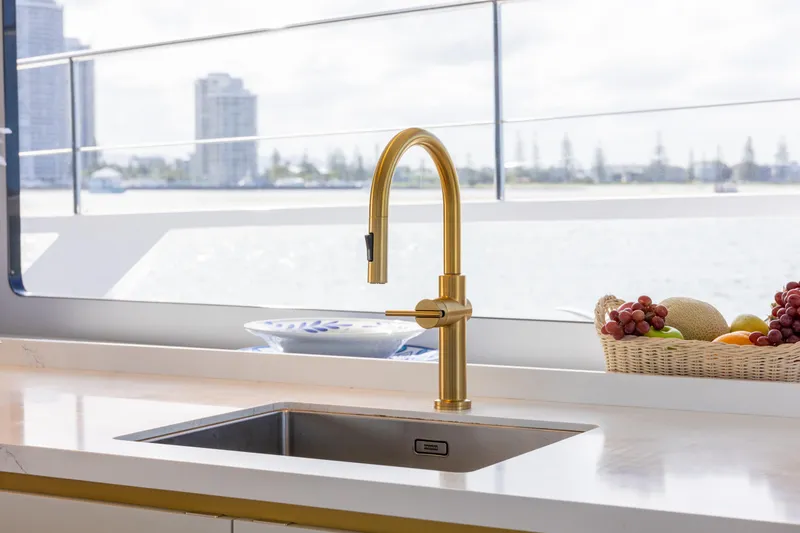 Slide: The Image of Luxurious McConaghy 82P yacht kitchen with gold faucet and fruit basket, 2026 model. - 17