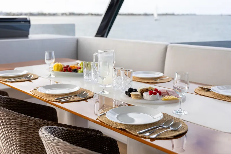 Slide: The Image of Luxurious dining setup on McConaghy 82P yacht, featuring elegant tableware and ocean view. - 18