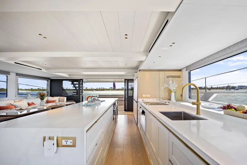 Slide: The Image of Luxurious McConaghy 82P yacht interior, featuring modern kitchen with ocean views, 2026 model. - 28