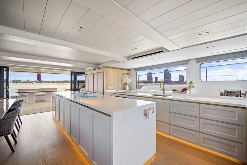 Slide: The Image of Luxurious interior of 2026 McConaghy 82P yacht with modern kitchen and scenic views. - 30