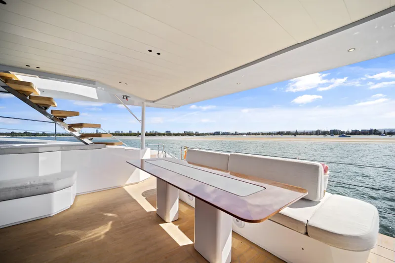 Slide: The Image of Luxurious McConaghy 82P yacht deck with seating, table, and ocean view, 2026 model. - 32