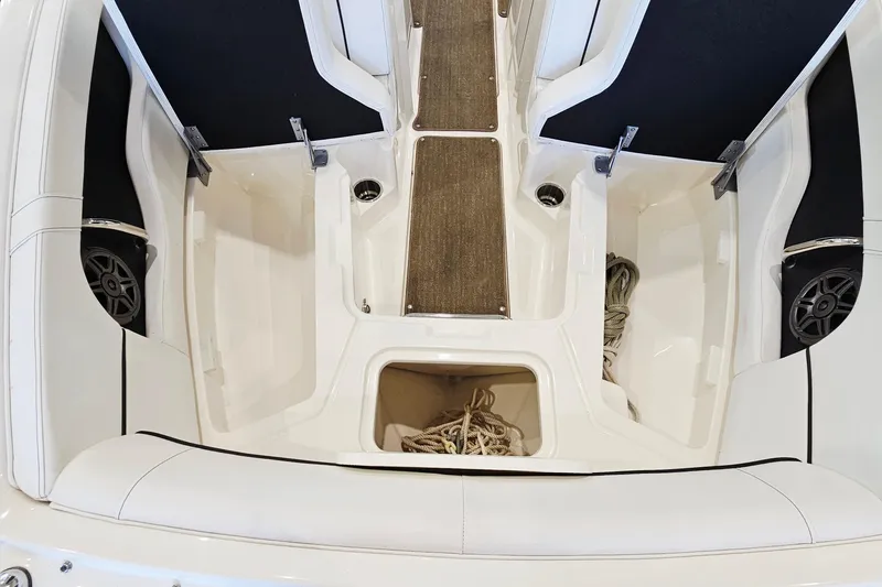Slide: The Image of 2014 Sea Ray 220 Sundeck Outboard interior with storage compartments and seating. - 20