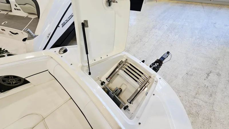 Slide: The Image of 2014 Sea Ray 220 Sundeck Outboard with open storage compartment and ladder. - 21