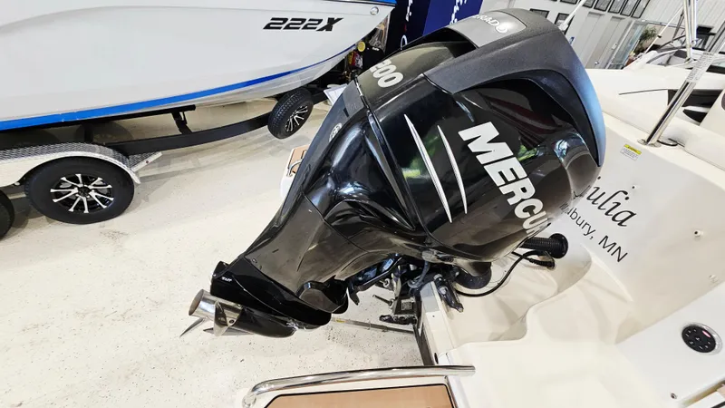 Slide: The Image of 2014 Sea Ray 220 Sundeck Outboard with Mercury engine, displayed indoors. - 28