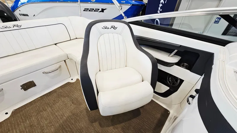 Slide: The Image of 2014 Sea Ray 220 Sundeck Outboard interior with white seating and modern design. - 9