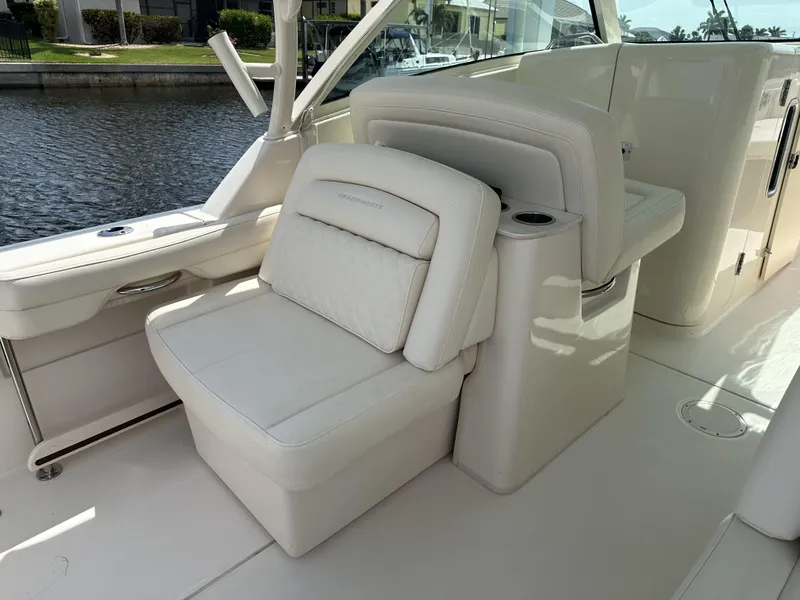 Slide: The Image of 2023 Grady-White Freedom 325 boat interior with white seating and cup holder. - 11