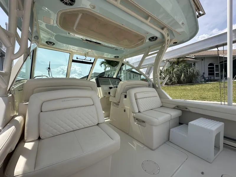 Slide: The Image of 2023 Grady-White Freedom 325 boat interior with luxurious seating and helm. - 12