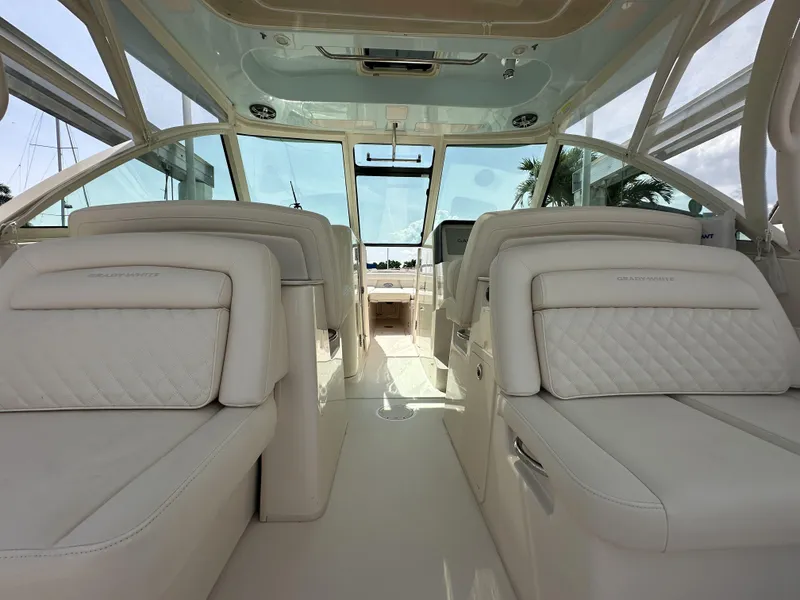 Slide: The Image of 2023 Grady-White Freedom 325 boat interior with luxurious seating and panoramic windows. - 13