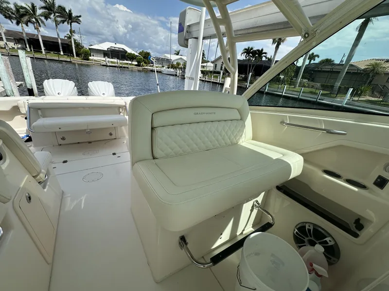 Slide: The Image of 2023 Grady-White Freedom 325 boat interior with luxurious seating and waterfront view. - 14