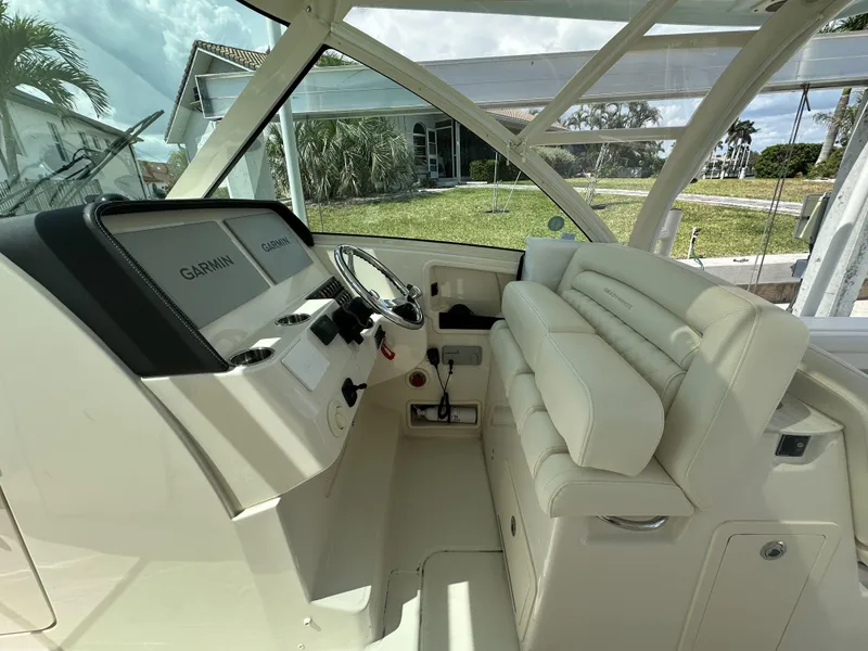 Slide: The Image of 2023 Grady-White Freedom 325 boat interior with helm and seating area. - 15