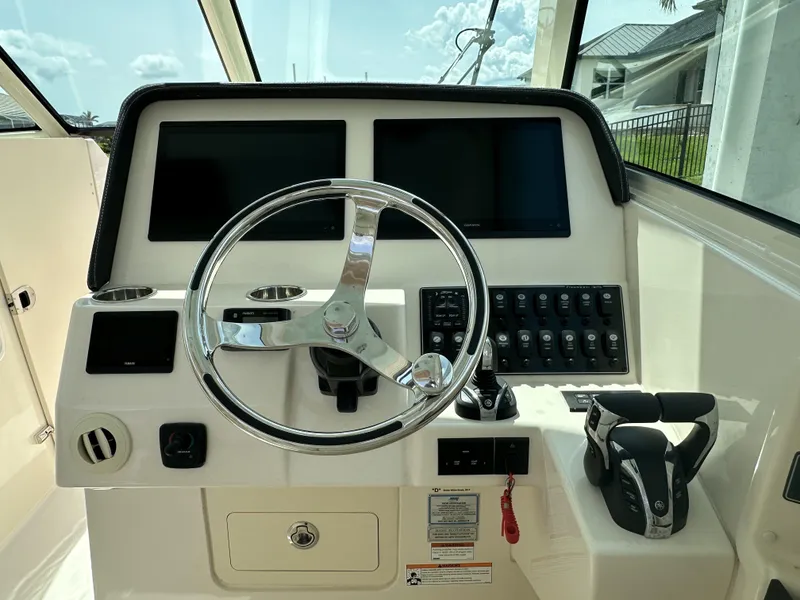 Slide: The Image of 2023 Grady-White Freedom 325 helm with dual screens and modern controls. - 16