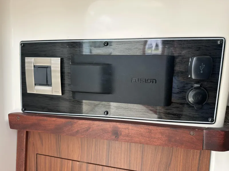 Slide: The Image of Control panel on 2023 Grady-White Freedom 325 boat, featuring USB and power outlets. - 19