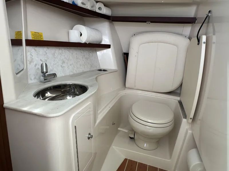 Slide: The Image of 2023 Grady-White Freedom 325 boat bathroom with sink, toilet, and storage shelves. - 20